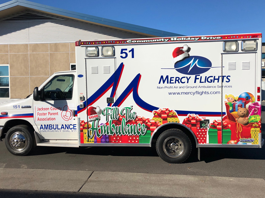 Mercy Flights staff works to fill ambulance with gifts for local foster kids and families